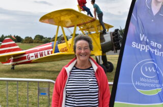 Maria smiling in front of plane ready to wingwalk