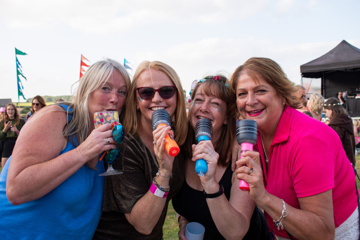 Music By The Lake 2023 Women posing with microphones