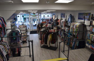 Lyme Regis Charity Shop Manager inside of the shop