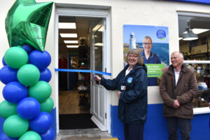 Paula Hartley from Weldmar Hospicecare cuts ribbon open at Weldmar Shop in Portland Reopen