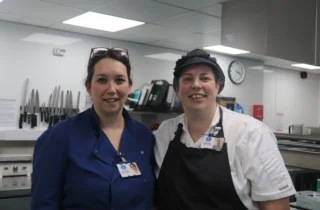 Sam, Catering and Nutrition Lead, and Liama, Chef, in the kitchen at Weldmar Hospicecare.