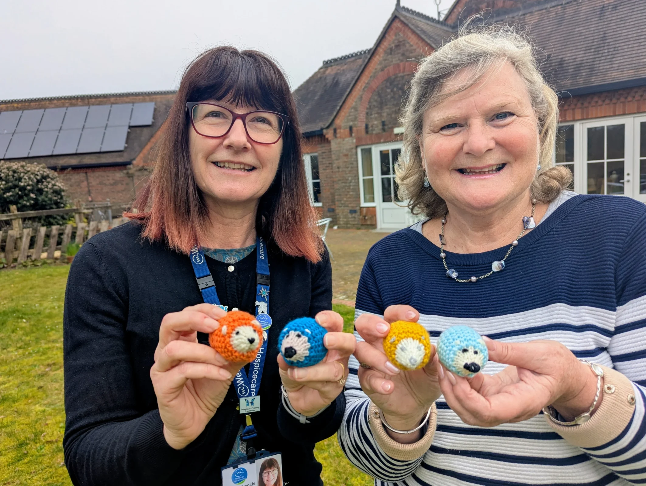 Sandra from Weldmar and Julia from Dorchester Family Church holding knitted hedgehogs