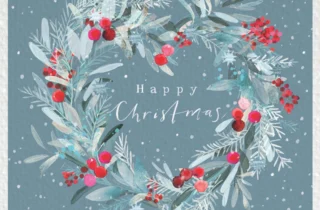 A silver Christmas wreath with bright red berries is in the centre of the crad. The background is a grey colour with snowflakes.