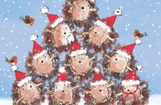 A group of hedgehogs wearing santa hats stand in a pyramid formation. Text on the front of the card says Hogs and Kisses at Christmas.